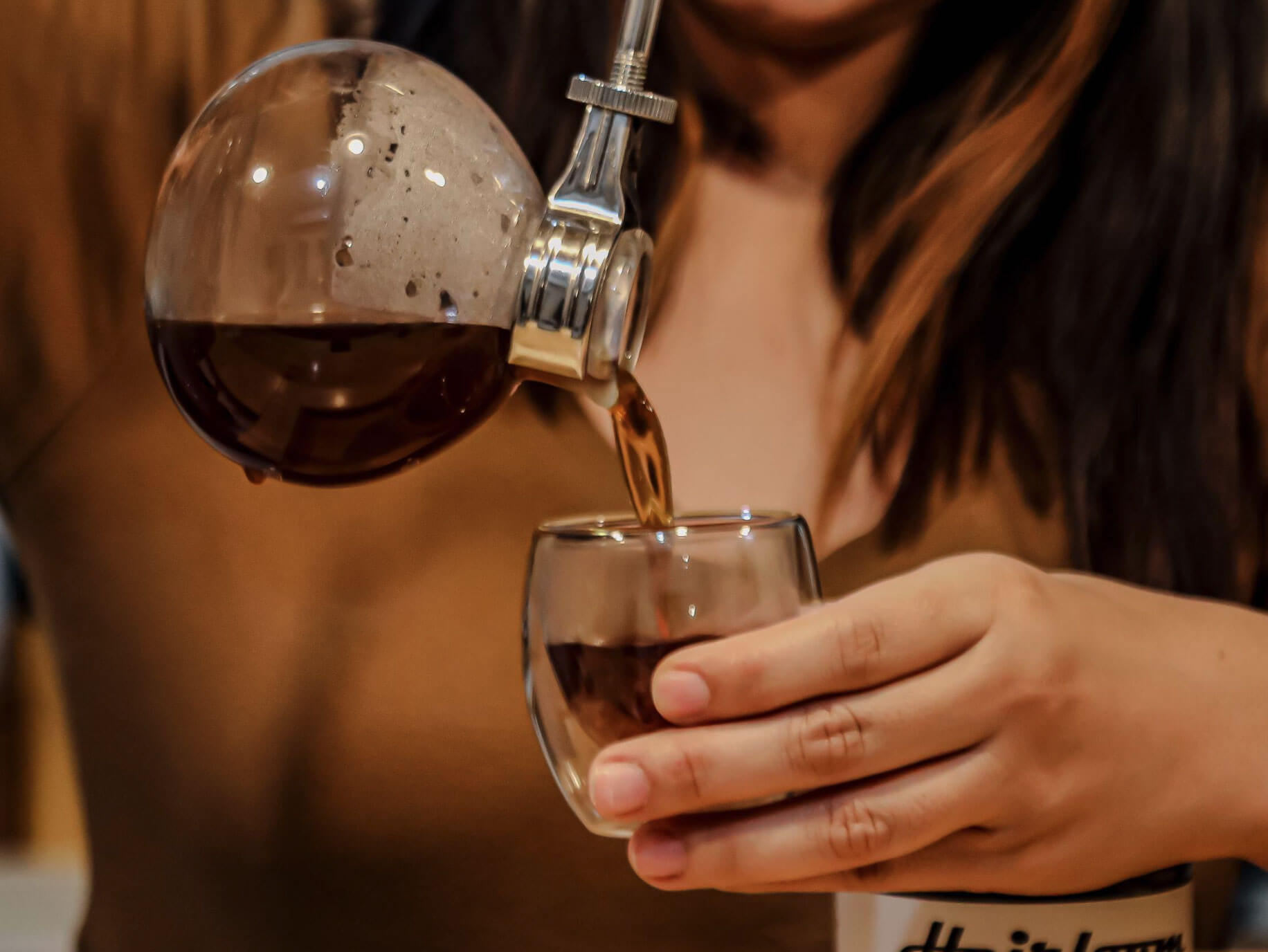 Barista serving siphon coffee at SLOW